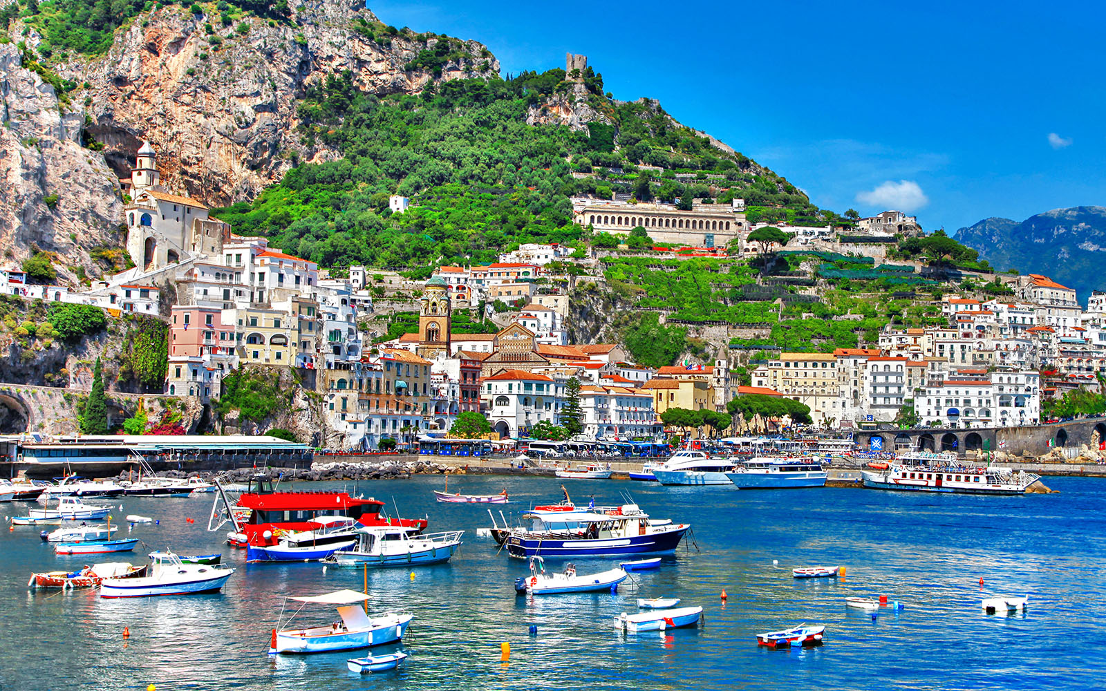 Amalfi Coast Italy scenic view with colorful cliffside buildings and Mediterranean Sea.